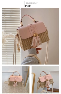 Detail view of pink leather and straw woven bag with decorative double tassels and rope strap