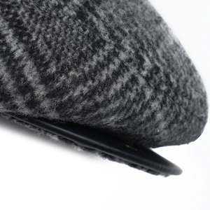 Close-up of wool texture and leather piping on a warm vintage winter cap for men