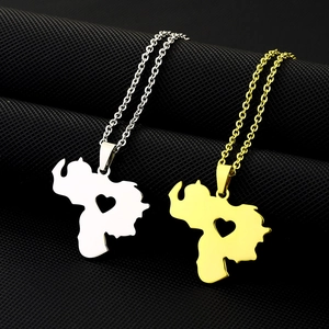 Detail of two stainless steel necklaces with hollow heart-shaped African map pendants