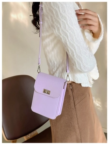 Detail view of mini lavender crossbody bag featuring accordion folds and metal buckle