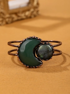 Detailed close-up of vintage bronze open bangle with green moonstone and labradorite gems