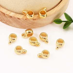 Cuentas espaciadoras doradas CCB de agujero grande para joyería DIY en soporte de madera
