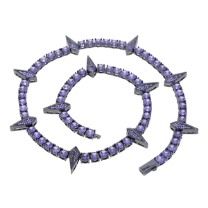 Detailed macro shot of 5mm black tennis chain with purple stones and spike pendant