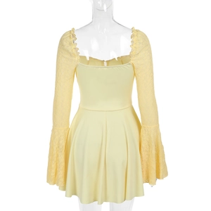 Detail view of the elegant lace trumpet sleeves and back hem on the yellow dress
