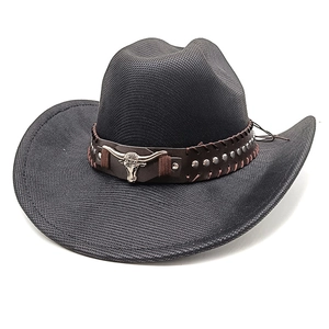 Detail of black cowboy hat featuring a leather band with metal studs and bull head emblem
