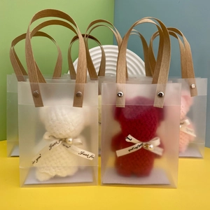 Frosted gift bags with knitted bears, pearl accents and 'Just for you' ribbons