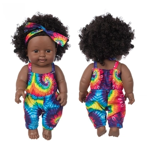 Front and back view of 12 inch African baby doll in colorful tie-dye jumpsuit and headband