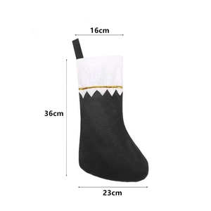 Detail view of black and white Christmas stocking with 16cm width and 36cm height dimensions