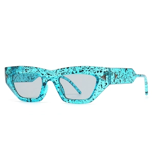 Trendy cat-eye blue ink patterned sunglasses with dark lenses and metal rivets