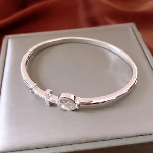 18K gold plated arrow cross cuff bracelet with pave crystals and peace sign charm
