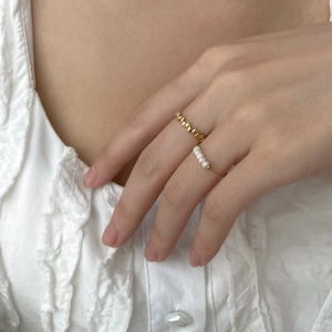 French minimalist gold rings set featuring geometric metal band and white pearl ring