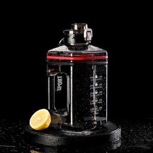 Detail of 2.2L sports water bottle with hourly time markers and motivational quotes