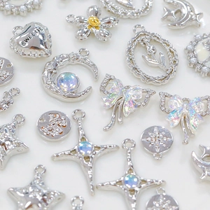 Flat lay of assorted silver-tone alloy charms with rhinestones for DIY jewelry making