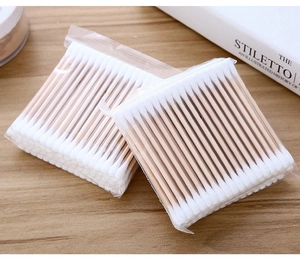 Detailed view of two packs of double-headed wood stick cotton swabs for daily personal care