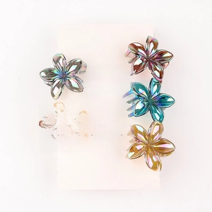 Detailed macro view of five-petal flower hair claws with colorful metallic coating finish