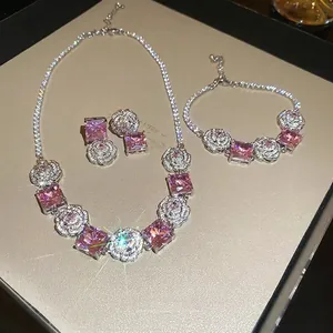 Elegant jewelry set with pink square gemstones and camellia flower motifs in silver finish