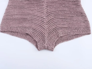 Close-up of pink knit shorts with textured herringbone pattern and wide stitching detail