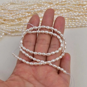 3-3.5mm natural freshwater rice pearls for DIY jewelry making held in hand
