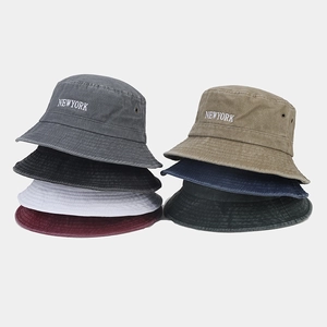 Detail showing various colors of vintage washed cotton bucket hats with New York embroidery
