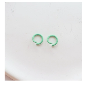 Detail of matte mint green jump rings for DIY jewelry making and keychain accessories