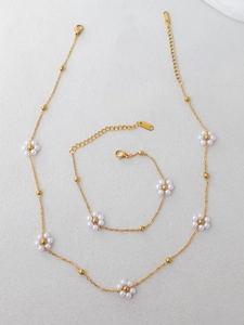 Detail of beaded flower jewelry set with stainless steel necklace and bracelet