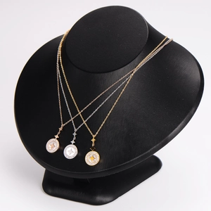 Minimalist stainless steel necklaces with star shell pendants on black display stand