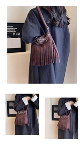 Close-up of brown suede crossbody bag with long fringes and detailed embroidery
