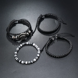 Detail view of a 4-piece men's leather bracelet set with eagle charm and beaded textures
