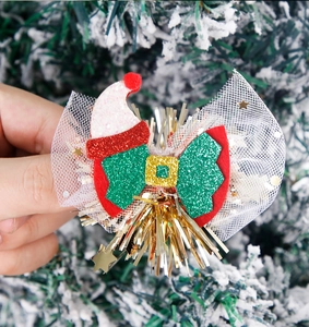 Detail of Christmas hairpin with glitter felt Santa hat and white polka dot mesh bow