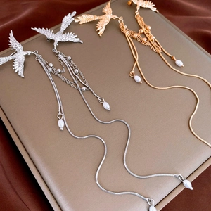 Elegant phoenix brooch with faux pearls and metal tassels on golden display box