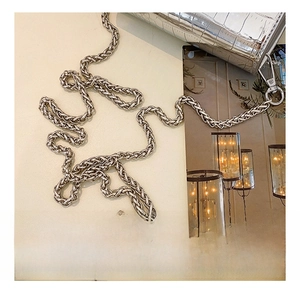 Detailed macro view of silver metal woven chain and crocodile texture leather on handbag