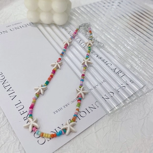 Colorful beaded necklace with white starfish pendants and silver lobster clasp closure