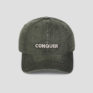 Detail of vintage washed green baseball cap with high-quality CONQUER 3D embroidery