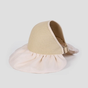 Detail of organza brim sun hat showing adjustable metal buckle and woven straw texture