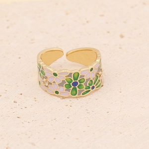Macro view of golden adjustable ring featuring daisy flower enamel and small crystal accents