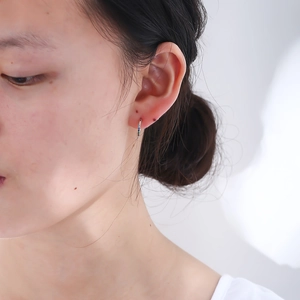 Close-up of S925 sterling silver C-shaped hoop earrings with colorful zircon on ear