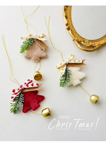 Close-up of plush Christmas tree bells with soft fur, festive bows, and Merry Christmas tags