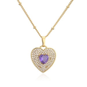 Macro detail of 18K gold-plated necklace featuring a purple zircon heart and pave crystals