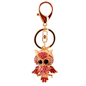 Golden owl keychain with red rhinestones and lobster clasp on white background