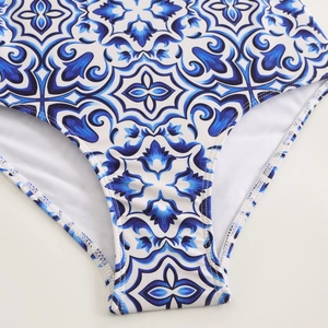 Detailed close-up of blue Majolica print on white one-piece swimsuit fabric with neat seams