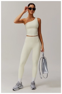 Detail showing the one-shoulder design and high-waist fit of the beige yoga sportswear set