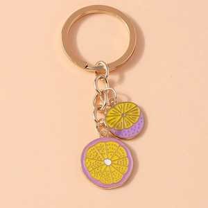 Detail view of colorful lemon slice enamel pendants on a gold keychain chain