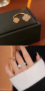 Detail of clover rings with pavé cubic zirconia in gold and silver finishes