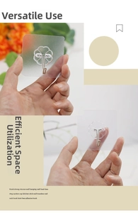 Nahaufnahme des blütenförmigen, transparenten Klebehakens mit schwenkbarem Edelstahlkopf