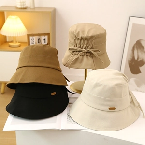 Chic women's cotton bucket hat with bow detail in beige, khaki, brown, and black colors