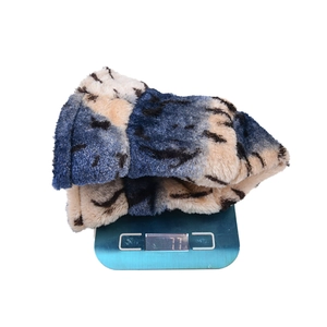 Winter plush leopard print bucket hat on electronic scale showing 77g lightweight design