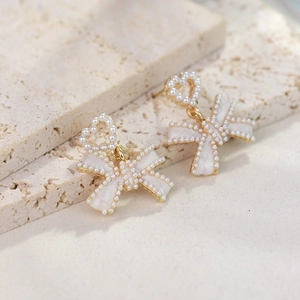 Elegant bow and heart drop earrings with delicate pearls and gold plating for women