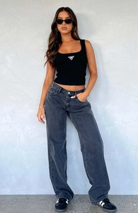 Close-up of the dark grey straight leg denim trousers with metal button details