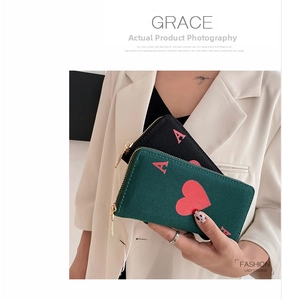 Detail of long canvas zip wallets in black and dark green with Ace of Hearts design