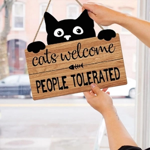 Close-up of wooden hanging sign with black cat silhouette and Cats Welcome text